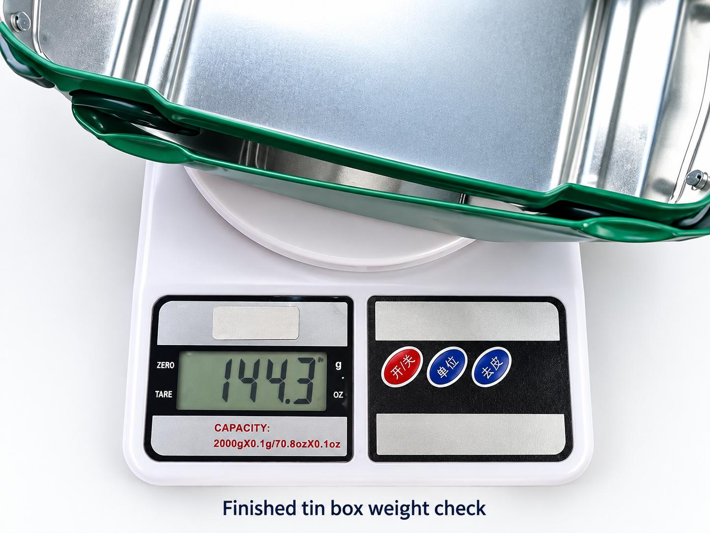 Finished tin box being weighed during quality inspection